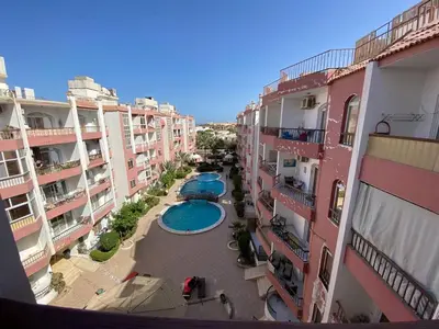 an aerial view of an apartment complex with a swimming pool at ديزرت بيرل in Hurghada