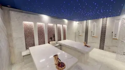a white bathroom with a sink and a mirror at Charming Marina Crib Pool Beach Gym Spa in Hurghada