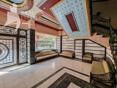 a room with a staircase with chairs and a window at Charming Marina Crib Pool Beach Gym Spa in Hurghada