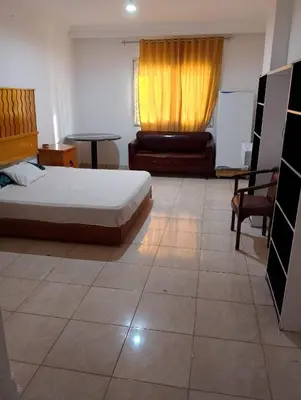 a bedroom with a bed and a couch and a table at Charming Marina Crib Pool Beach Gym Spa in Hurghada