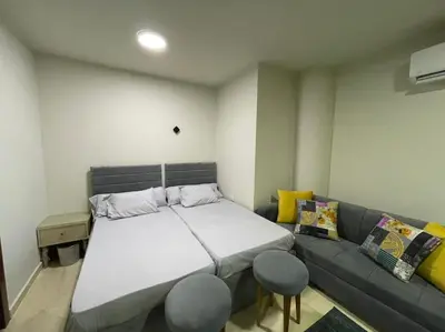 a bedroom with a large bed and a couch at Cozy Studio With Private Beach ! in Hurghada