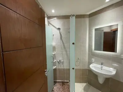 a bathroom with a shower and a sink and a mirror at Cozy Studio With Private Beach ! in Hurghada