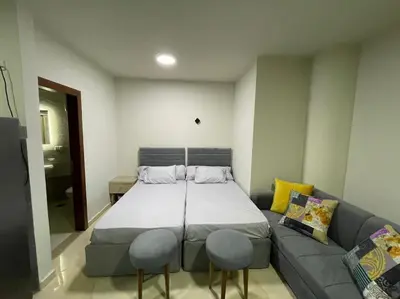 a large bed in a room with a couch at Cozy Studio With Private Beach ! in Hurghada