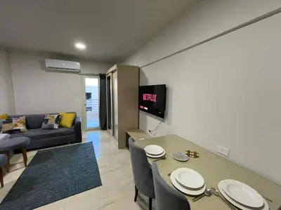 a living room with a table and a couch at Cozy Studio With Private Beach ! in Hurghada