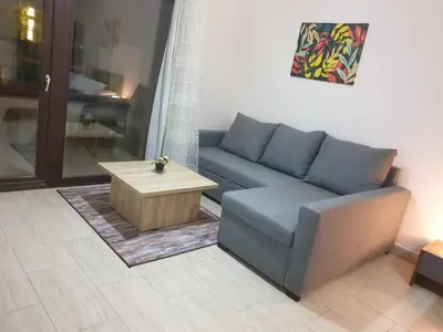 a living room with a couch and a coffee table at 3316- Awesome Garden view studio in Al Dau Heights in Hurghada
