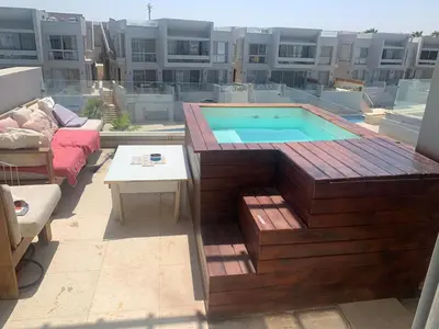 a swimming pool on top of a building at 1BR with private Heated Jacuzzi at Sholan Elgouna in Hurghada