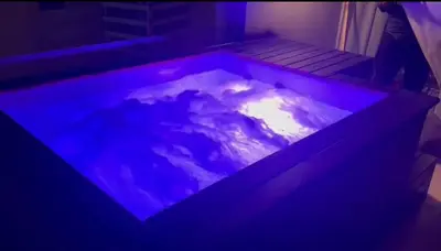 a pool of water with purple lights in a room at 1BR with private Heated Jacuzzi at Sholan Elgouna in Hurghada