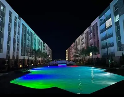a large pool of water with buildings at night at Fanadir Bay Resort in Hurghada, Egypt in Hurghada