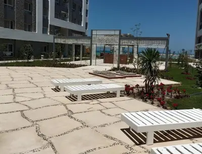 a group of white benches sitting on a patio at Fanadir Bay Resort in Hurghada, Egypt in Hurghada