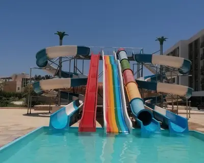a water slide in a pool with a rainbow at Fanadir Bay Resort in Hurghada, Egypt in Hurghada