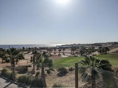 a view of the beach and palm trees at Sea & Golf Views 2BR Villa with Free Beach & Pool Access in Hurghada