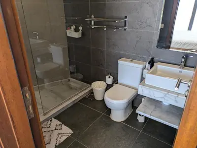 a bathroom with a toilet and a shower and a sink at Sea & Golf Views 2BR Villa with Free Beach & Pool Access in Hurghada