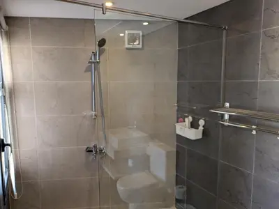 a bathroom with a shower with a glass door at Sea & Golf Views 2BR Villa with Free Beach & Pool Access in Hurghada