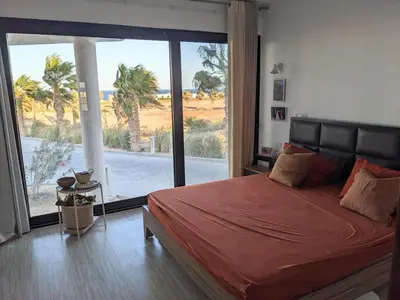 a bedroom with a large bed and a large window at Sea & Golf Views 2BR Villa with Free Beach & Pool Access in Hurghada