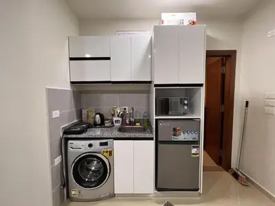 a small kitchen with a washing machine and a washer at Charming 1-Bed Chalet in Hurghada in Hurghada