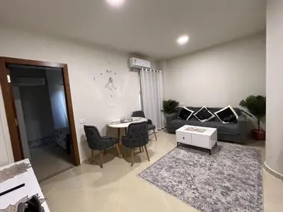 a living room with a table and a couch at Charming 1-Bed Chalet in Hurghada in Hurghada