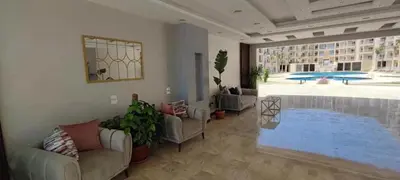 a living room with couches and a swimming pool at Charming 1-Bed Chalet in Hurghada in Hurghada