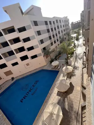 a swimming pool in front of a hotel at Charming 1-Bed Chalet in Hurghada in Hurghada