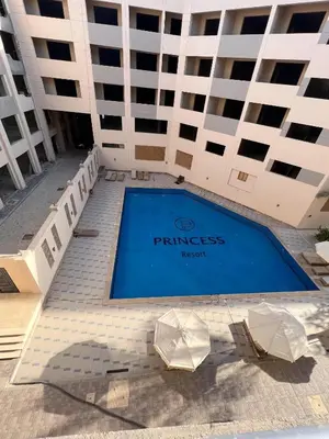 a building with a swimming pool in front of a building at Charming 1-Bed Chalet in Hurghada in Hurghada