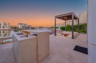a rooftop patio with a bar and a view of the city at Comfy 3BR Standalone in Tawila, El Gouna. Lagoon & Pool access in Hurghada