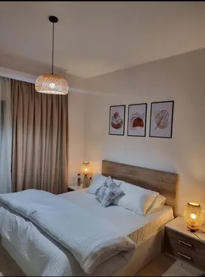 a bedroom with a bed and a chandelier at Tolles Modernes Studio in Aldau in Hurghada