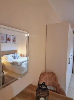 a mirror in a room with a bed and a chair at Tolles Modernes Studio in Aldau in Hurghada