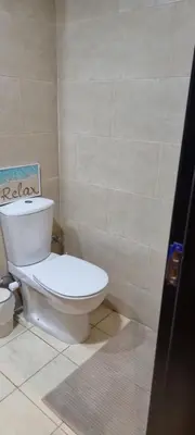 a bathroom with a white toilet in a room at Tolles Modernes Studio in Aldau in Hurghada
