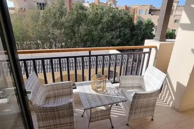 a patio with a table and chairs on a balcony at Tolles Modernes Studio in Aldau in Hurghada
