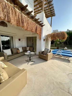 a patio with couches and a table and a building at GS 23 in Hurghada