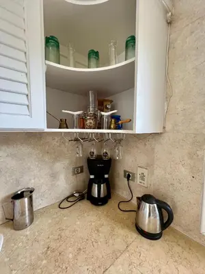 a kitchen counter with a coffee maker and pots and pans at GS 23 in Hurghada