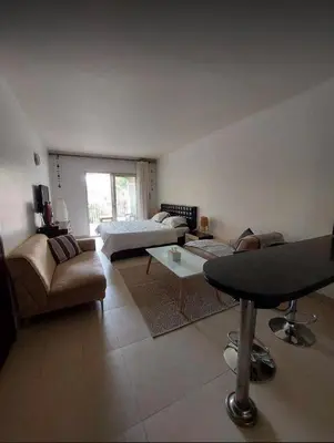 a living room with a couch and a table at Stunning Pool View 1bed Private Beach Access, Veranda Sahl Hasheesh in Hurghada