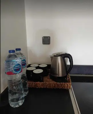 a counter with a tea pot and water and drums at Stunning Pool View 1bed Private Beach Access, Veranda Sahl Hasheesh in Hurghada