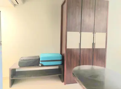 a room with two pieces of luggage sitting on a bench at Stunning Pool View 1bed Private Beach Access, Veranda Sahl Hasheesh in Hurghada