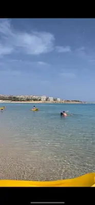 two people swimming in the water in the ocean at Stunning Pool View 1bed Private Beach Access, Veranda Sahl Hasheesh in Hurghada