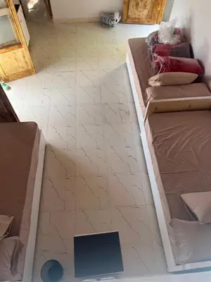a living room with a couch and a tile floor at Salatoos Mango Garden and Guesthouse in Aswan