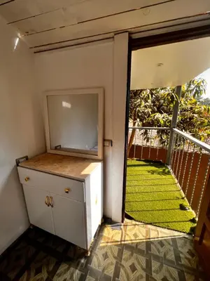 a room with a door open to a balcony withgrass at Salatoos Mango Garden and Guesthouse in Aswan