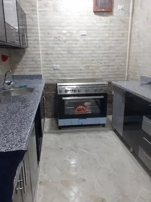a kitchen with a stove with food inside of it at Sun, Sea & Comfort in Hurghada