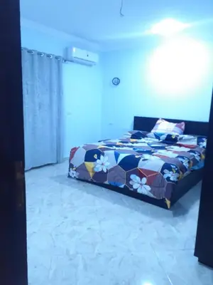 a bedroom with a bed with a colorful comforter at Sun, Sea & Comfort in Hurghada