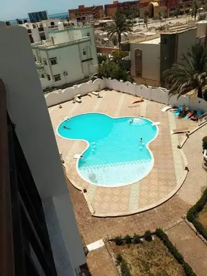 a large swimming pool on top of a building at Makramia studio in Hurghada