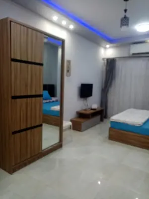 a room with two beds and a mirror at Makramia studio in Hurghada