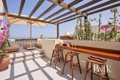 a patio with a bar with a view of the ocean at BYTK - Casa Del Mar in Hurghada