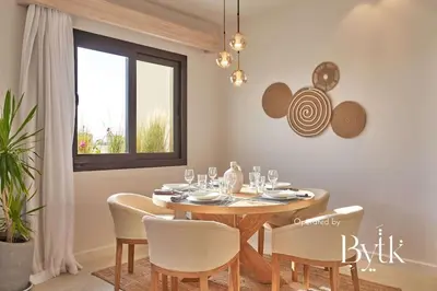 a dining room with a wooden table and chairs at BYTK - Casa Del Mar in Hurghada