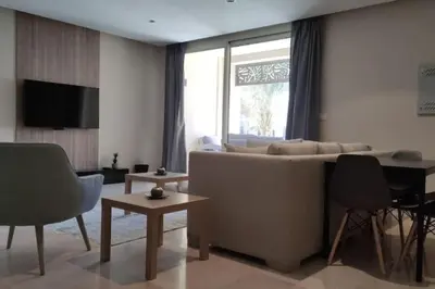a living room with a couch and a table at Mangroovy Magic PoolView 1BR in Beachfront Complex M3 3A 13 in Hurghada