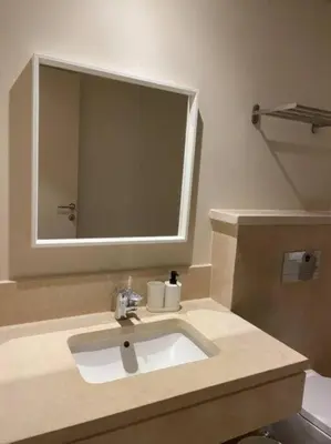 a bathroom with a sink and a mirror at Mangroovy Magic PoolView 1BR in Beachfront Complex M3 3A 13 in Hurghada