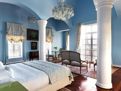 a bedroom with blue walls and a bed and chairs at La Maison Bleue El Gouna in Hurghada