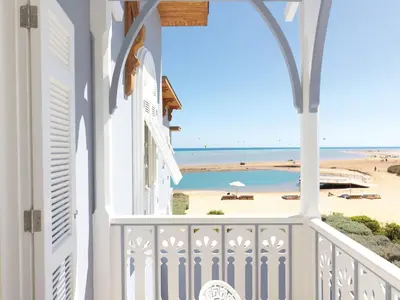 a view of the beach from the balcony of a beach house at La Maison Bleue El Gouna in Hurghada