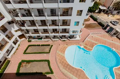 an overhead view of a building with a swimming pool at Makramia A107 studio in Hurghada