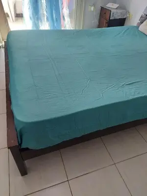 a bed with a blue sheet on top of it at Makramia A107 studio in Hurghada