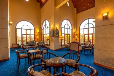 a waiting room with tables and chairs and windows at Akassia Swiss Resort in Quseir