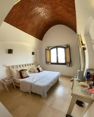 a bedroom with a large bed and a window at Spacious Villa with private pool-Gouna in Hurghada